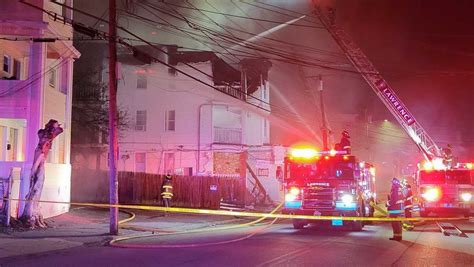 Crews battle fire at Lawrence triple-decker where front of building collapsed